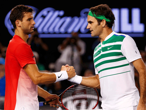 Switzerland's Federer shakes hands with Bulgaria's Dimitrov after Federer won their third round match at the Australian Open tennis tournament at Melbourne Park. Reuters