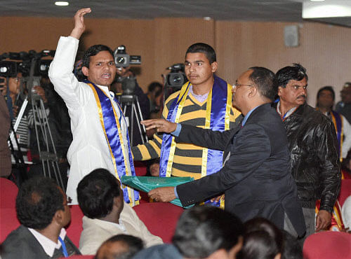 Two students raising slogan against PM Narendra Modi at the convocation of BR Ambedkar university in Lucknow on Friday. PTI photo