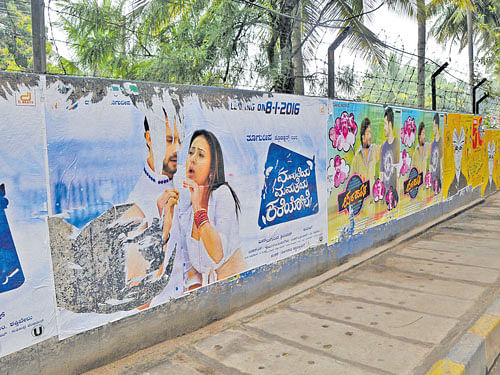 eyesore The City's walls and public places are defaced by film posters. DH photo by BK Janardhan