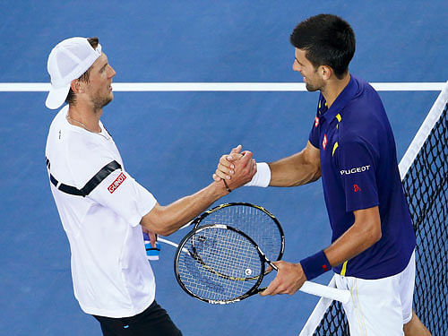 Serbia's Djokovic shakes hands with Italy's Seppi after Djokovic won their third round match at the Australian Open tennis tournament at Melbourne Park. Reuters Photo.