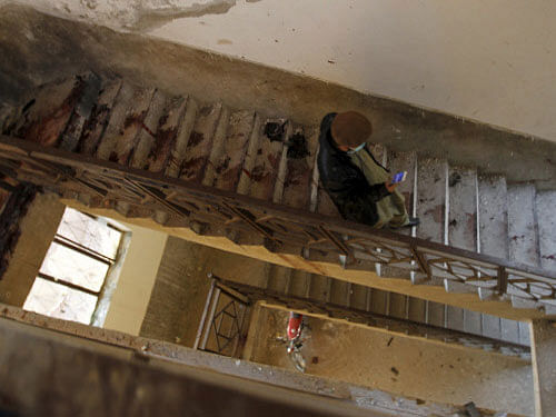 A man walks down the blood-stained stairs leading down from the roof of a dormitory where a militant attack took place, at Bacha Khan University in Charsadda, Pakistan. Four persons have been arrested in Pakistan for facilitating the deadly Taliban attack on the prestigious university. Reuters photo