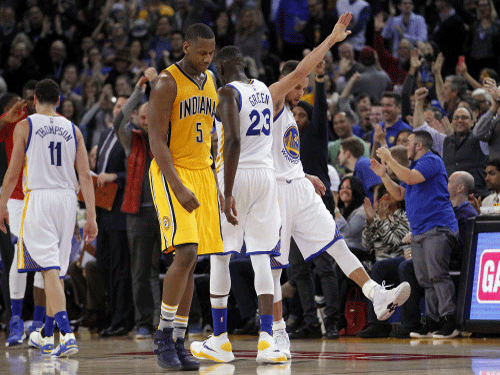 Golden State Warriors guard Stephen Curry (30) reacts after making a three point basket against the Indiana Pacers in the fourth quarter at Oracle Arena. Reuters File Photo.