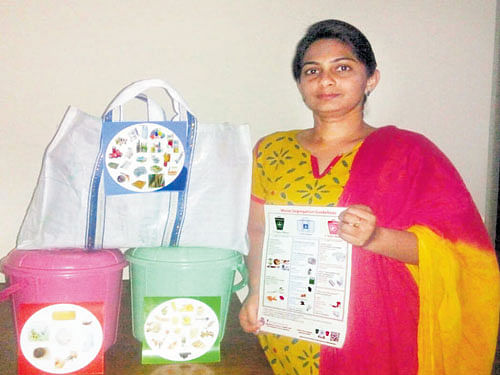 Priyadarshini Raghuram, a waste management volunteer, displays the 'two bins one bag' system which is increasingly being adopted by households in the City. DH photo