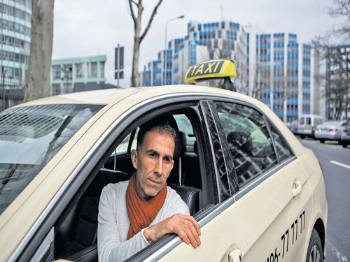 face of protest: Hasan Kurt, the owner of a local licensed taxi business in Frankfurt, who refused to work with Uber when it tried to recruit licensed operators to build its service within the letter of the law, in front of the German stock exchange in Eschborn, Germany. nyt