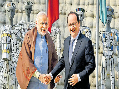 French President Francois Hollande is greeted by PM Narendra Modi at the Rock Garden of Chandigarh on Sunday. PTI