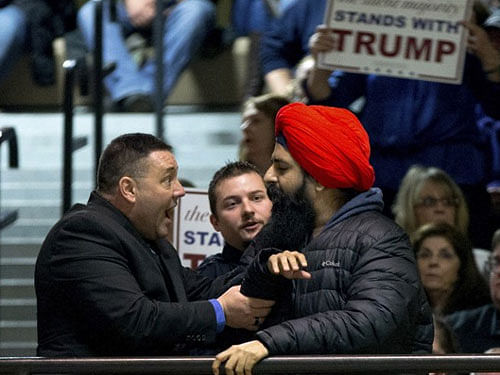 The man, wearing in bright red turban, started his peaceful protest impromptu, when Trump was addressing an impressive campaign rally yesterday with his signature anti-Muslim speech. reuters file photo