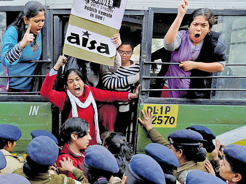 Student shout slogan demanding resignation of Union HRD Minister Smriti Irani as they are detained during a protest against the death of scholar Rohith Vemula in New Delhi on Wednesday. PTI