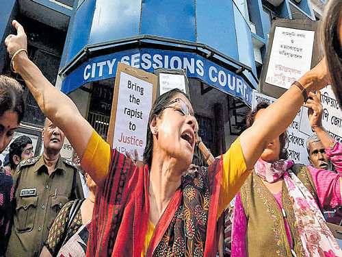 Women shout slogans in front of a local court during a hearing in the Kamduni gang-rape and murder case in Kolkata on Thursday. PTI