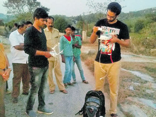 Technicians check the functioning of a drone used to trace the bear which escaped from the Bannerghatta Biological Park (BBP) on Thursday. DH photo