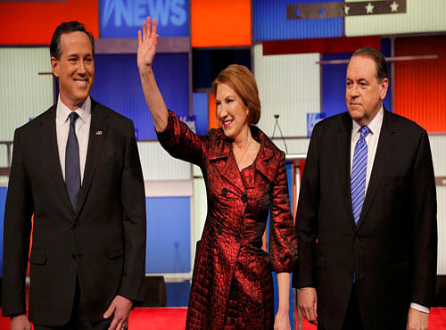 Republican U.S. presidential candidates Santorum, Fiorina and Huckabee pose together before the start of a forum for the lower polling presidential candidates in Des Moines. Reuters photo