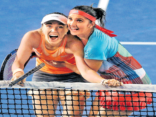 awesome twosome: Sania Mirza (right) and Martina Hingis showed why they are the World No 1 pair, winning the Australian Open doubles title in straight sets on Friday. AP/ pti