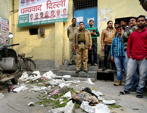 MCD workers throw garbage in front of Transport Minister Gopal Rai's office at Babarpur during their protest in New Delhi on Friday. PTI Photo