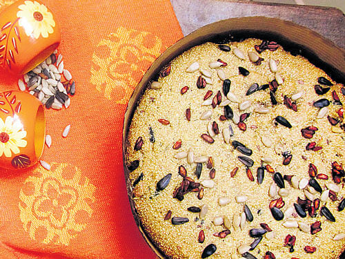 INVITING Whole-wheat amaranth cake topped with sunflower and pomegranate seeds.