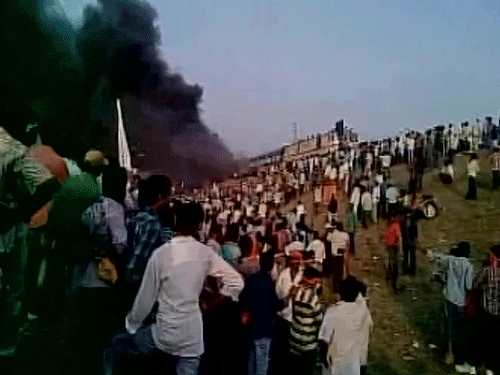 Protesters from Kapu community,demanding BC status,burn 2 coaches of Ratnachal express in Tuni city. Courtesy: ANI