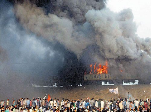 Agitators set fire to Ratnachal Expresswhen it halted at Tuni railway station in East Godavari district on Sunday. PTI