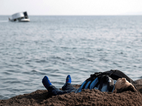 The dead body of a migrant boy lies on the beach near the Aegean town of Ayvacik, Canakkale, Turkey, Saturday, Jan. 30, 2016. A boat carrying migrants to Greece hit rocks off the Turkish coast on Saturday and capsized, killing at least 33 people, including five children, officials and news reports said. Some 75 other migrants were rescued. A Turkish government official said he expects the death toll from the incident to rise as rescue workers try to reach other migrants believed trapped inside the wreckage of the boat which sank shortly after departing from the Aegean resort of Ayvacik. AP/ PTI