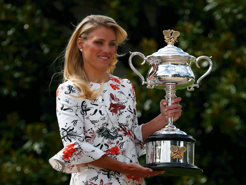 Germany's Angelique Kerber poses with the women's singles trophy a day after winning her final match at the Australian Open tennis tournament, at the Government House in Melbourne, Australia, January 31, 2016. Reuters File Photo.
