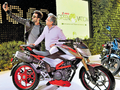 Hero brand ambassador Ranbir Kapoor takes a selfie with Hero MotoCorp CMD Pawan Munjal at the Hero Pavilion at the Auto Expo in Greater Noida, New Delhi on Saturday. PTI