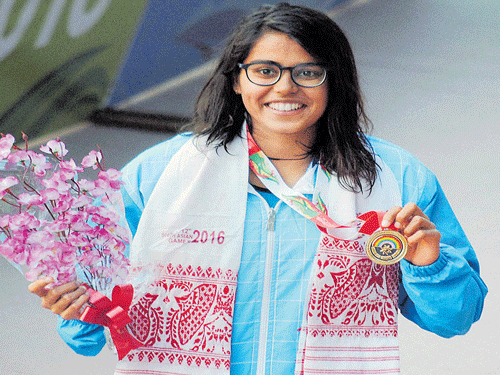 all smiles: India's Shivani Kataria after winning the 200M freestyle gold on Saturday. PTI
