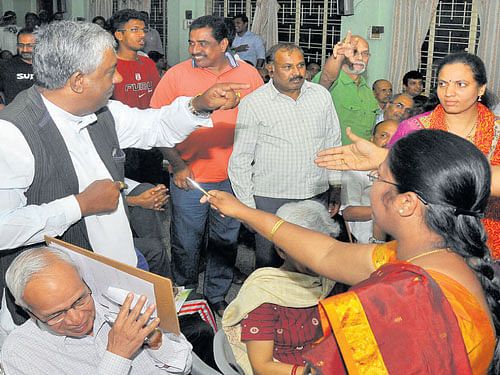 Citizens argue with the candidates for Hebbal bypoll at an  interaction in the City on Saturday. dh photo