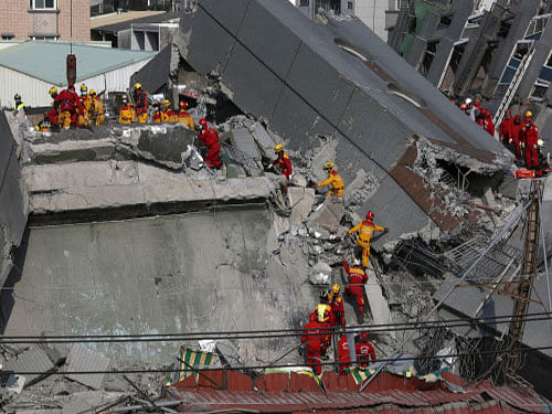 Rescue personnel search the rubble of a 17-storey apartment building that collapsed after an earthquake hit Taiwan, reuters file photo