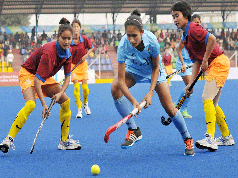Indian and Nepal women Hockey Team players in action during the 12th South Asian Games in Guwahati on Sunday. PTI Photo
