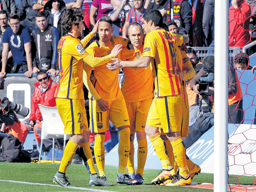 closely knit Barcelona's Luis Suarez (right) celebrates with his team-mates after scoring against Levante in their La Liga tie on&#8200;Sunday. Barca won 2-0. reuters