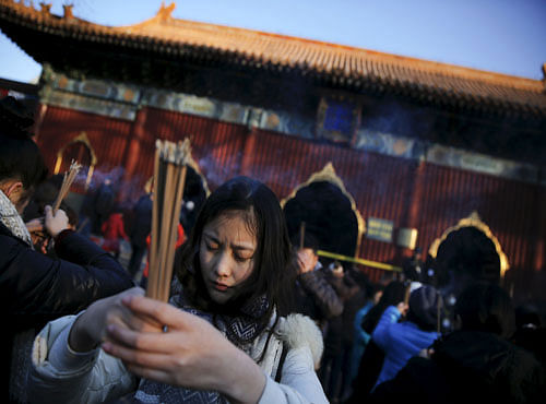 People burn incense and pray for good fortune on the first day of the Lunar New Year of the Monkey at Yonghegong Lama Temple in Beijing. Reuters file photo