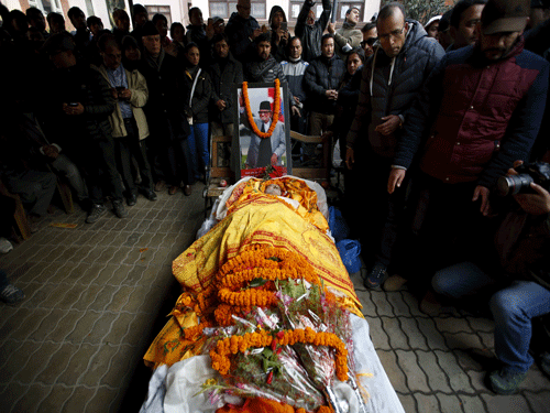 People gather around the body of former Prime Minister Sushil Koirala in Kathmandu. Reuters Photo.