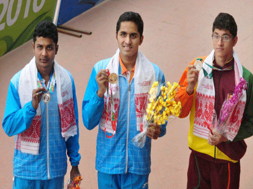 Gold medalist Saurabh Sangvekar of India (M), with silver medalist Sajan Prakash of India (L) and bronze medalist Kyele Abeysingh of Sri Lanka (R) showing their medals after 400M swimming event at the 12th South Asian Games 2016, in Guwahati on Tuesday. PTI Photo.