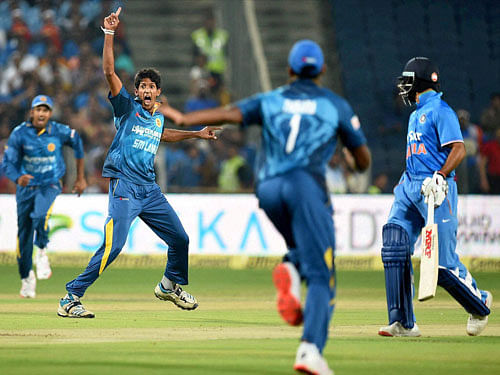 Sri Lankan bowler Kasun Rajitha celebrates the wicket of Indian batsman Ajinkya Rahane during the first T20 match in Pune on Tuesday. PTI Photo