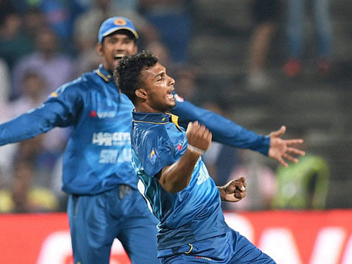 Sri Lankan bowler Dasun Shanaka celebrates the wicket of Indian batsman MS Dhoni during the first T20 match in Pune on Tuesday. PTI Photo