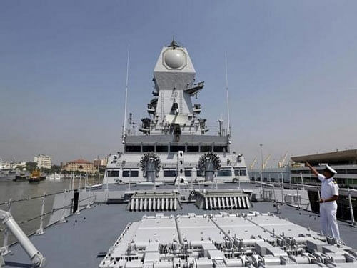 An Indian Navy personnel gestures on the deck of the newly built INS Kochi, a guided missile destroyer, during a media tour at the naval dockyard in Mumbai, Reuters photo