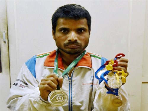 Special athlete Hamid shows his National and International level medals, in Lucknow on Wednesday. Hamid is compelled to work as labourer for livelihood. He was promised a job as well as financial assistance by then Chief Minister Mayawati. PTI Photo.