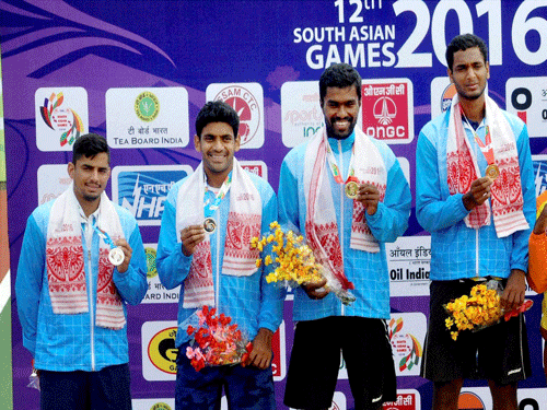 Gold medal winners Prasanth Vijay Sundar, Ramkumar Ramanathan and Silver medal winners Divij Sharan, Sanam Singh poses with their medals during the presentation ceremony after winning mens doubles final in Lawn Tennis at 12th South Asian Games in Guwahati on Wednesday. PTI Photo.