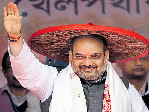 BJP President Amit Shah  after being felicitated with traditional Assamese Japi" and Gamocha during party workers rally in Nagaon on Wednesday. PTI