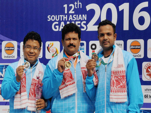 Gold medal winner Samaresh Jung (C), silver medal winner Pemba Tamang (L), and bronze medal winner Vijay Kumar of India showing their medals in the 25m center fire pistol competition at 12th South Asain Games in Guwahati in Thursday. PTI Photo.