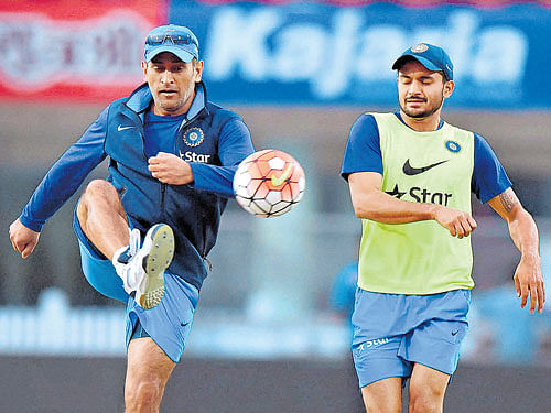 Indian captain MS Dhoni (left) with Manish Pandey during a practice  session on the eve of thier T20 tie against Sri Lanka in Ranchi on Thursday. PTI