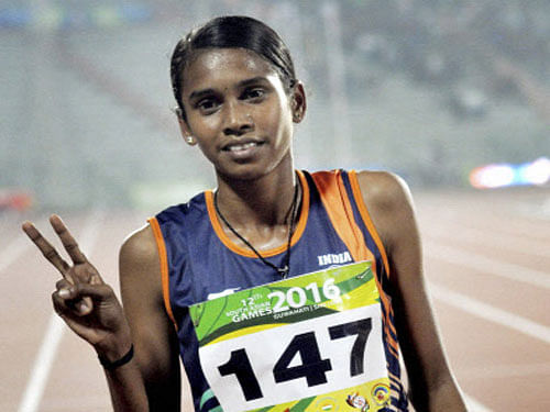 India's Chitra P U flashes the victory sign after winning the women's 1500M gold ahead of Sri Lanka's GTA Abeyrathna. PTI