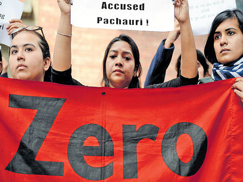 Struggle continues: Women hold a banner during a protest outside TERI&#8200;office against its vice-chairman R K Pachauri in New Delhi on Friday. AFP