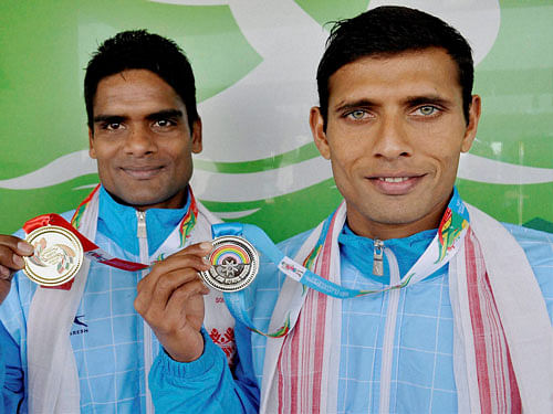 Gold medal winner Dilip Kumar and silver medalist Guru Dutt of India pose after men's Triathlon race at the 12th South Asian Games 2016 in Guwahati on Saturday. PTI Photo