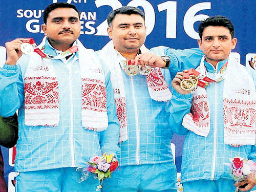 all smiles: India's Surendra Singh Rathod (left), Gagan Narang (centre) and Chain Singh after winning the men's 50M rifle 3-position team event on Sunday. PTI