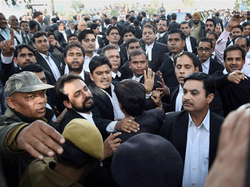Advocates clash with the JNU students who were protesting against the arrest of JNUSU President Kanhaiya Kumar at Patiala House Courts in New Delhi on Monday. PTI Photo.