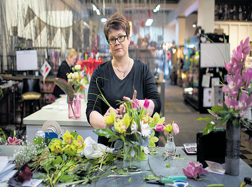 BLOSSOMING OUT: Rhoda Paurus,owner of St Cloud Floral. National merchants like 1-800-Flowers and FTD.com can take more than 25 per cent of a sale from local florists, but several start-ups, such as Bloom Nation, are challenging that model. NYT