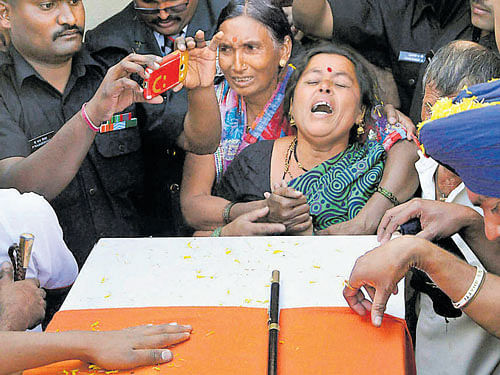 Mother of Sepoy Sunil Suryavanshi cries during his cremation ceremony at Maskarwadi Village in Satara, Maharashtra on Tuesday. PTI