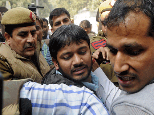 Kanhaiya Kumar (C), head of the student union at Delhi's Jawaharlal Nehru University (JNU), is escorted by police outside the Patiala House court in New Delhi, India. February 17, 2016. Fighting broke out on Wednesday around Delhi's Patiala House court hearing a case against Kumar accused of sedition, a charge that has sparked protests across university campuses and criticism the government was curtailing free speech. Reuters Photo.