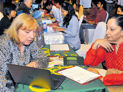 overseas opportunities: Students and parents participate in the 'Study Abroad Education Fair' organised in Bengaluru on Wednesday. dh Photo