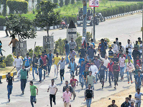 on a rampage: Jat community members turn violent during their agitation for reservation in Rohtak on Friday. PTI
