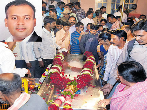 People pay their last respects to N Harish (inset).