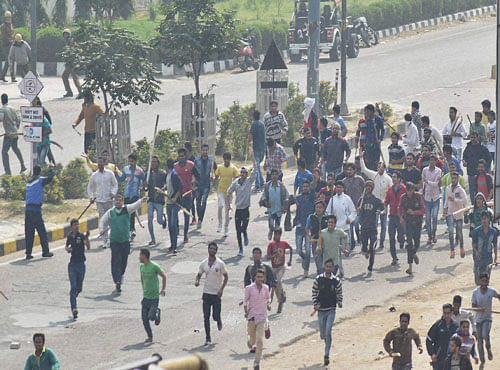 : Jat community members turn violent during their agitation for reservation in Rohtak on Friday. PTI Photo